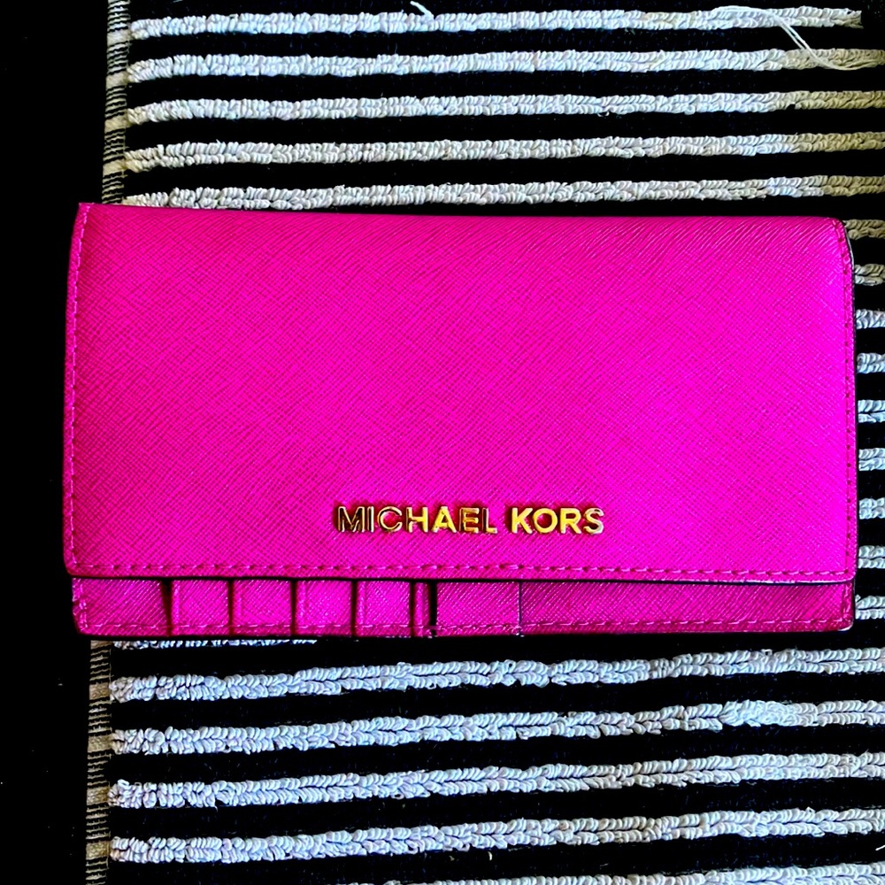 Michael Kors pink large wallet perfect condition.  Wonderful durable leather.
